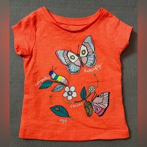 Carters baby girl pinkish-orange T-shirt with Butterfly/insect graphics. 3m